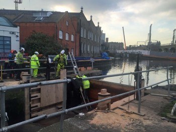 Men at work: it will cost £100K to replace the water gates. Photo: TK