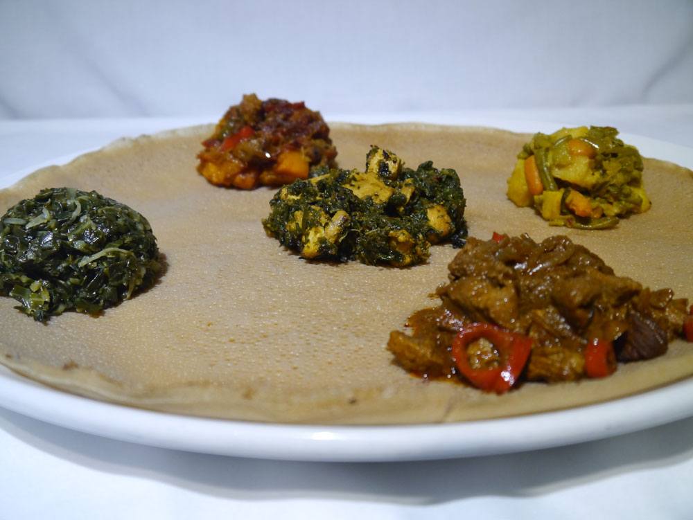 The chicken dish is in the centre of this photo, on injera bread. Photo: Lalibela