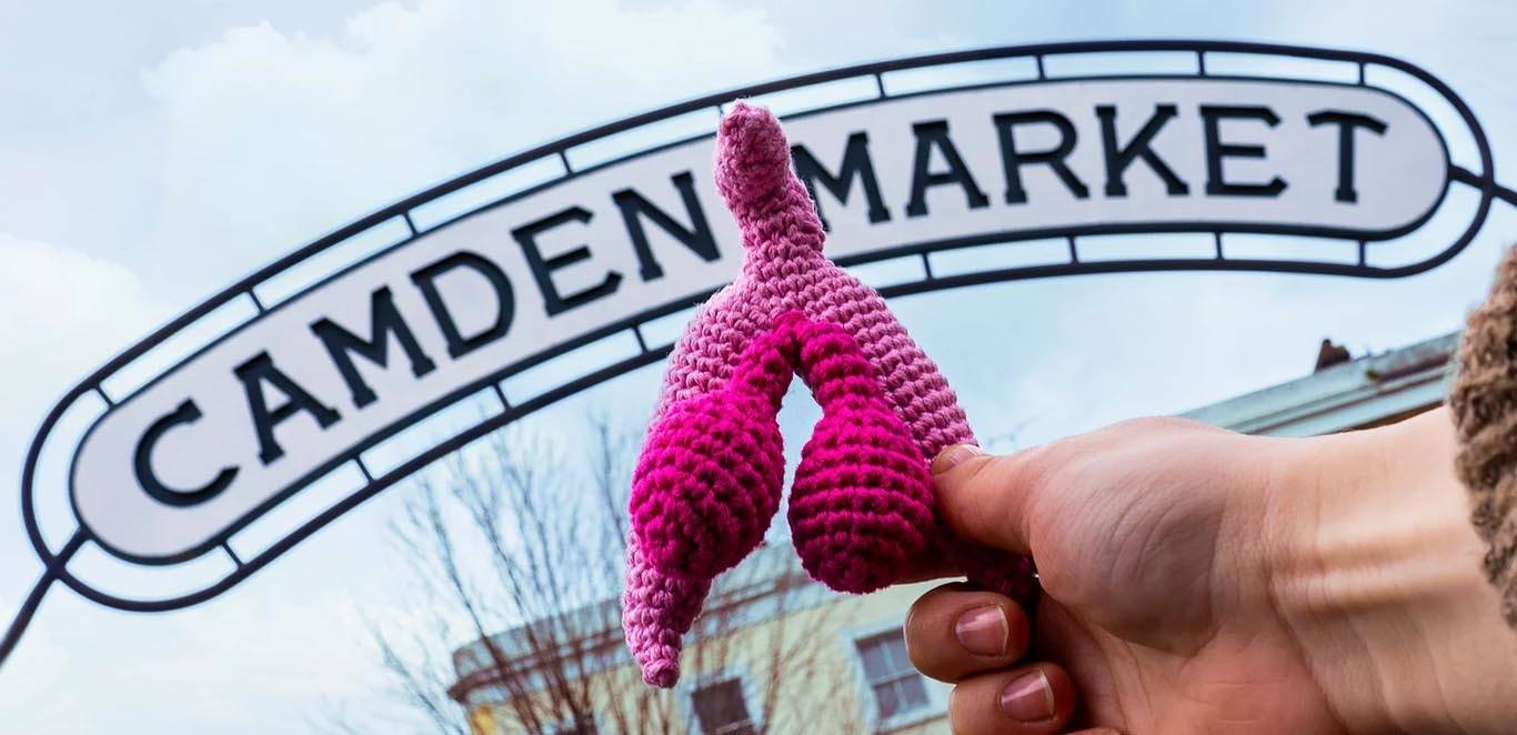 Knitted clitoris art in front of the Camden Market sign